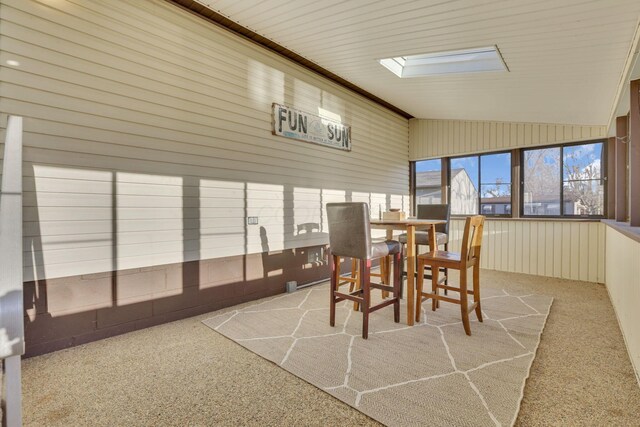 sunroom featuring a skylight and outdoor dining space
