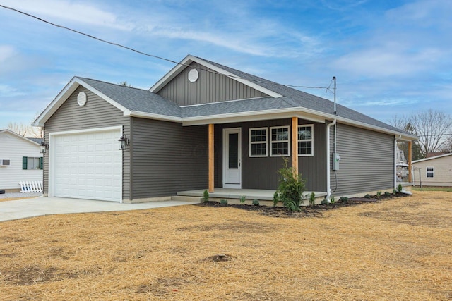 1651 Hillcrest Ave, Obetz, OH 43207 - view of front of house with driveway, board and batten siding, roof with shingles, covered porch, and a garage