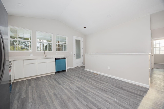 1651 Hillcrest Ave, Obetz, OH 43207 - kitchen with dishwashing machine, wood finished floors, a sink, vaulted ceiling, and white cabinets