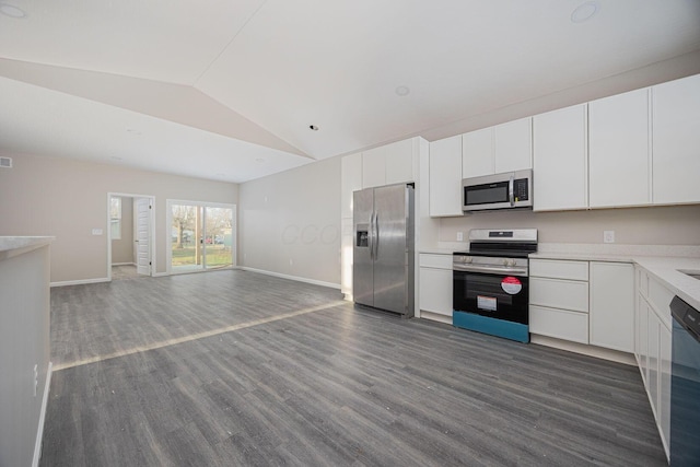 1651 Hillcrest Ave, Obetz, OH 43207 - kitchen featuring white cabinetry, appliances with stainless steel finishes, dark wood finished floors, and vaulted ceiling