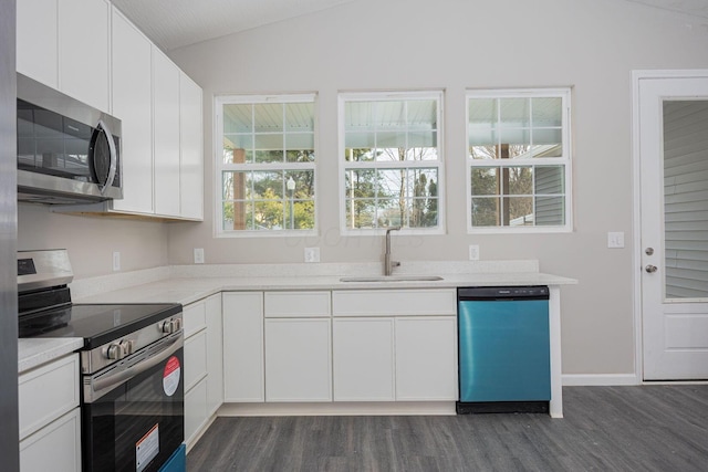 1651 Hillcrest Ave, Obetz, OH 43207 - kitchen with dark wood-type flooring, vaulted ceiling, appliances with stainless steel finishes, white cabinets, and a sink