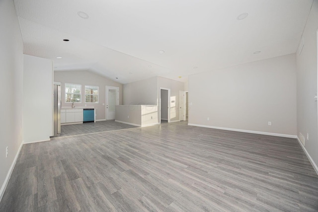 1651 Hillcrest Ave, Obetz, OH 43207 - unfurnished living room with vaulted ceiling, wood finished floors, and baseboards