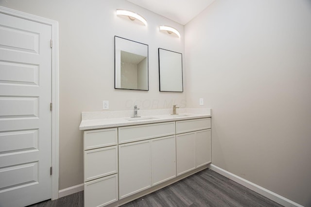 1651 Hillcrest Ave, Obetz, OH 43207 - bathroom with a sink, baseboards, wood finished floors, and double vanity