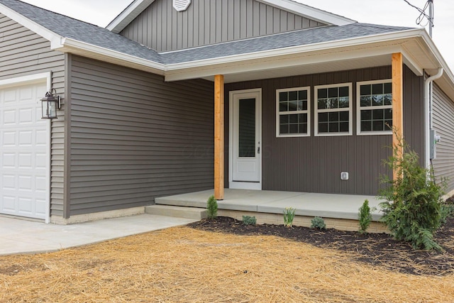 1651 Hillcrest Ave, Obetz, OH 43207 - view of exterior entry featuring a porch, an attached garage, board and batten siding, and a shingled roof