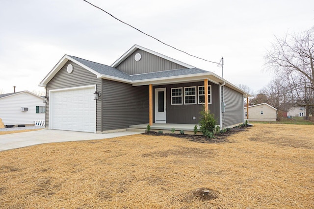 1651 Hillcrest Ave, Obetz, OH 43207 - view of front of property with covered porch, board and batten siding, concrete driveway, and a garage