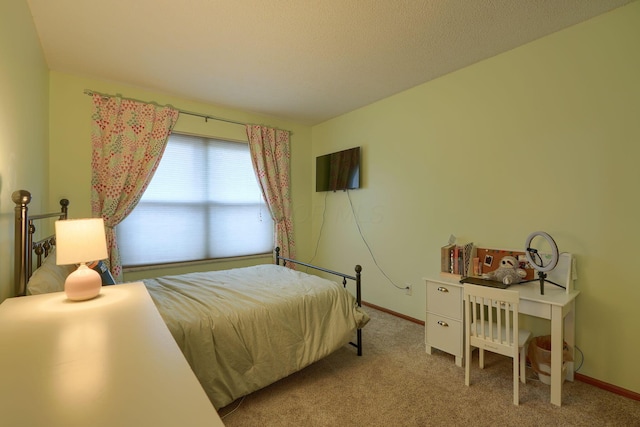 carpeted bedroom featuring baseboards