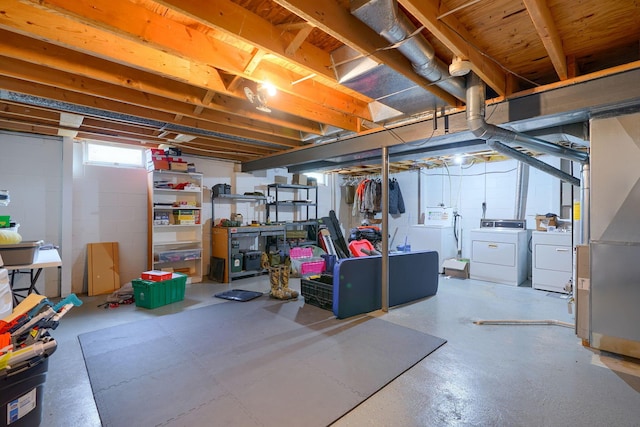 below grade area featuring independent washer and dryer and concrete block wall