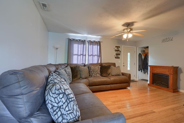 145 Danbury Rd, West Jefferson, OH 43162 - living room featuring a fireplace, ceiling fan, visible vents, and light wood-type flooring