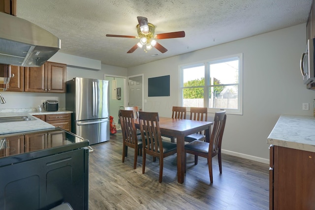 145 Danbury Rd, West Jefferson, OH 43162 - dining area featuring baseboards, ceiling fan, dark wood-style flooring, and a textured ceiling