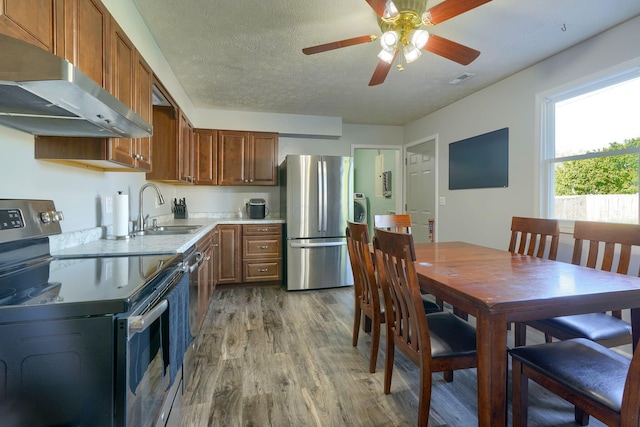 145 Danbury Rd, West Jefferson, OH 43162 - kitchen featuring a sink, light countertops, extractor fan, light wood-style flooring, and stainless steel appliances