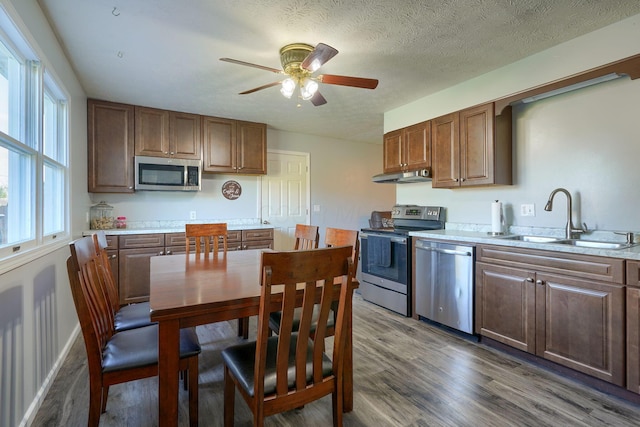 145 Danbury Rd, West Jefferson, OH 43162 - kitchen featuring a sink, appliances with stainless steel finishes, under cabinet range hood, and a healthy amount of sunlight