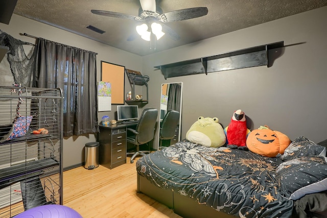 145 Danbury Rd, West Jefferson, OH 43162 - bedroom with a textured ceiling, a ceiling fan, wood finished floors, and visible vents