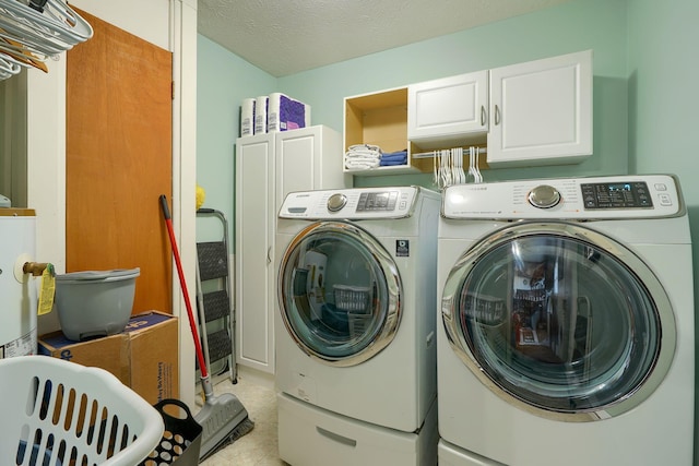 145 Danbury Rd, West Jefferson, OH 43162 - laundry room featuring cabinet space, light tile patterned flooring, and washer and clothes dryer