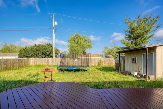145 Danbury Rd, West Jefferson, OH 43162 - deck featuring a trampoline, a storage shed, a fenced backyard, an outdoor structure, and a yard
