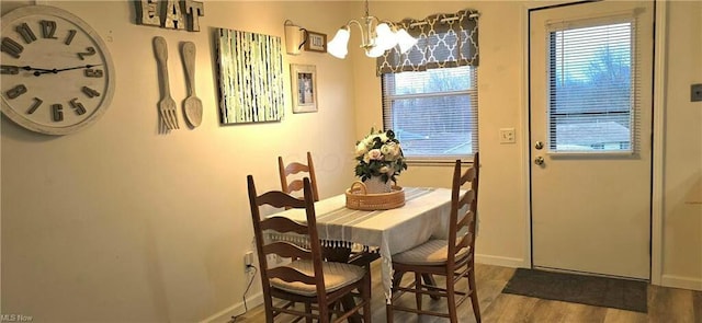 dining room with an inviting chandelier, wood finished floors, and baseboards