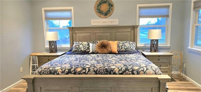 bedroom featuring baseboards and wood finished floors