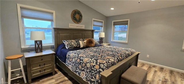 bedroom featuring recessed lighting, baseboards, light wood-style floors, and vaulted ceiling