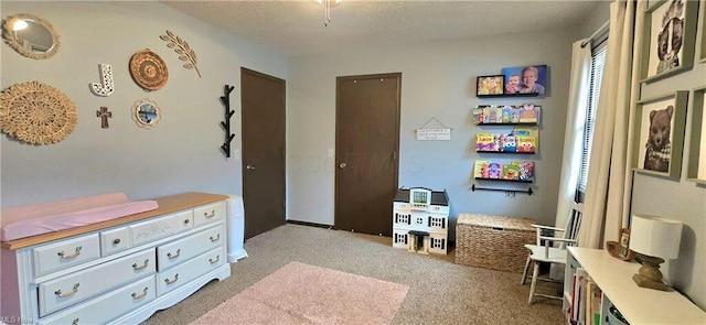 bedroom with light carpet and a textured ceiling