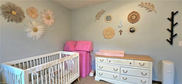 carpeted bedroom with a crib