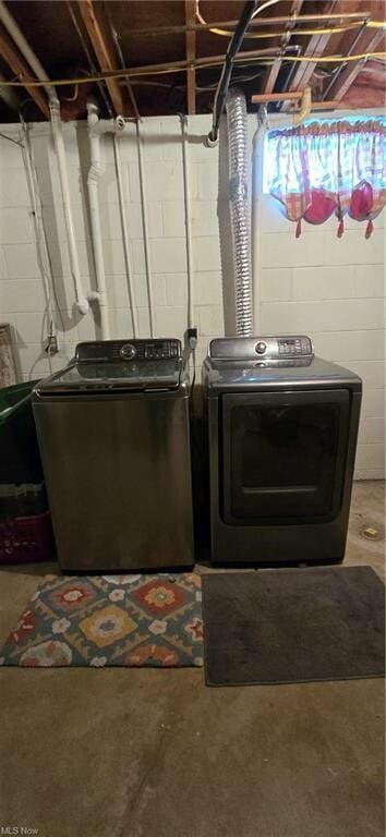 clothes washing area featuring washer and dryer and laundry area