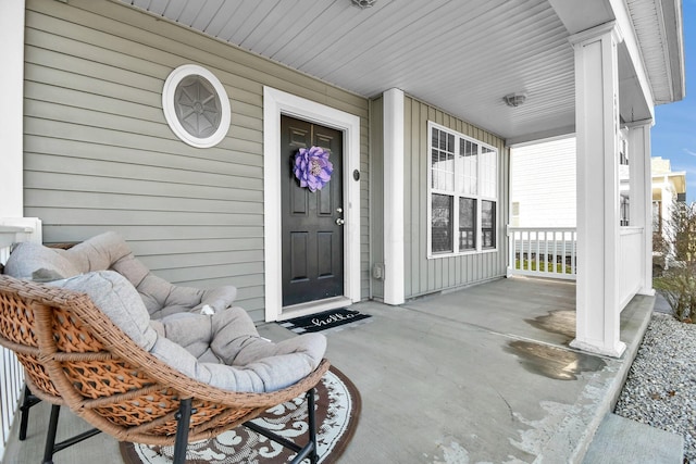 property entrance with board and batten siding and a porch