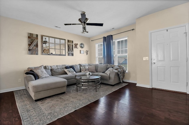 living room featuring baseboards, visible vents, a ceiling fan, and wood-type flooring