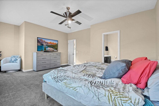 carpeted bedroom with baseboards, ensuite bath, and ceiling fan