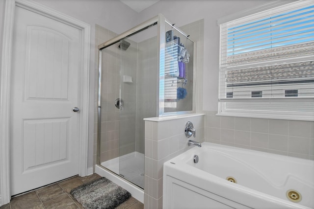 bathroom featuring a jetted tub and a stall shower