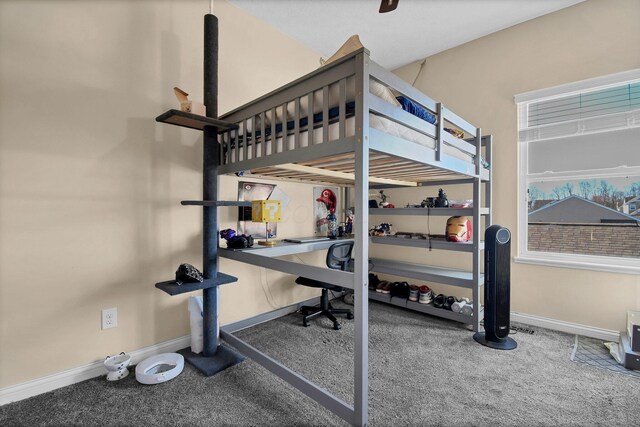 bedroom with carpet floors and baseboards