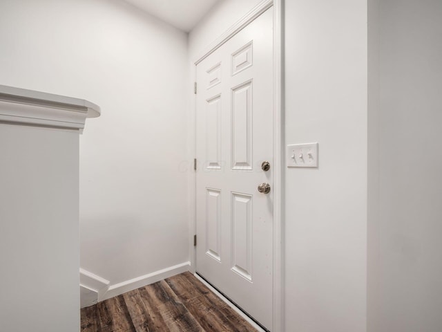 doorway to outside featuring dark wood-style floors and baseboards