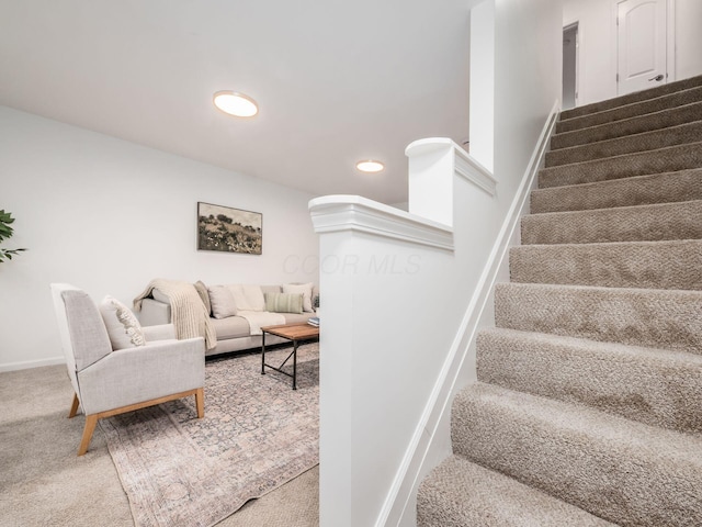 stairs featuring carpet and baseboards