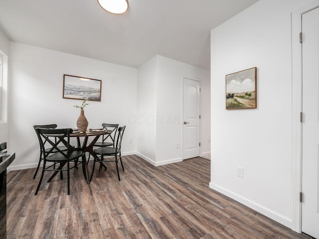 dining room featuring baseboards and wood finished floors