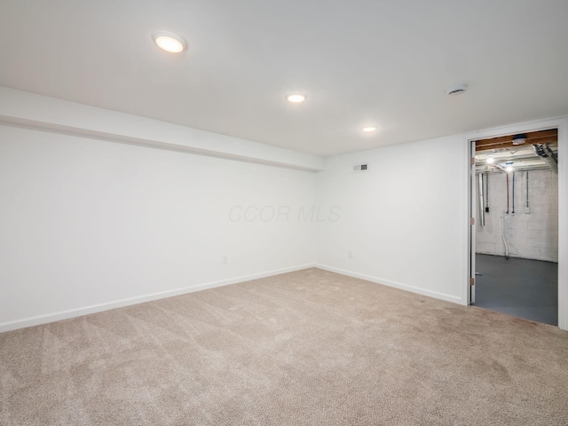 finished basement with recessed lighting, visible vents, baseboards, and carpet flooring