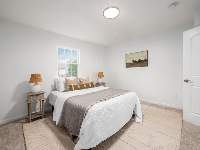 bedroom with carpet flooring and baseboards