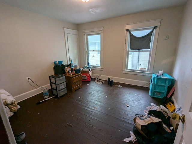 bedroom with baseboards and hardwood / wood-style flooring