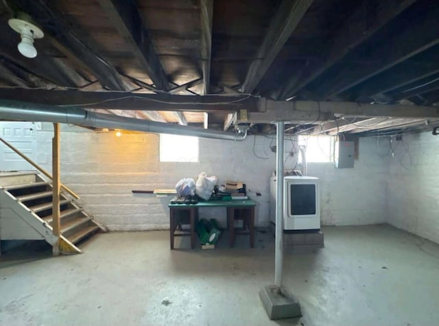 below grade area with stairs, washer / dryer, and electric panel
