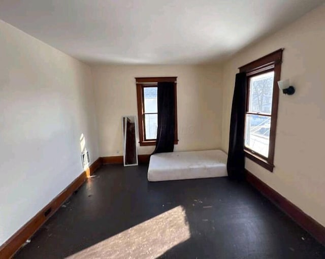 unfurnished room featuring baseboards