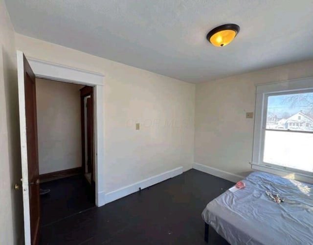 unfurnished bedroom featuring baseboards