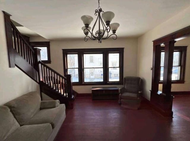 foyer with stairs, a notable chandelier, and baseboards