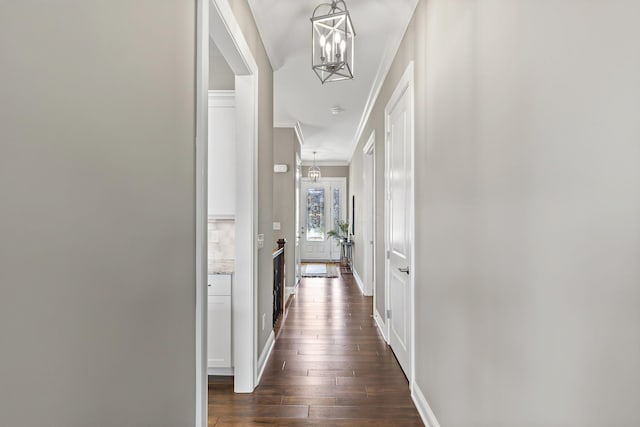 1462 Dogwood Loop, Powell, OH 43065 - hall featuring baseboards, dark wood-style floors, a chandelier, and crown molding