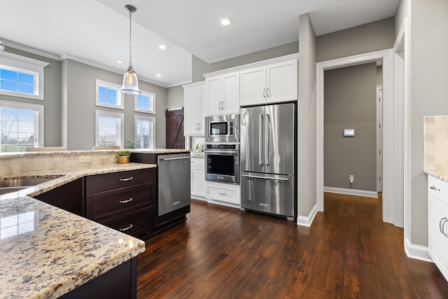 1462 Dogwood Loop, Powell, OH 43065 - kitchen with dark wood-style flooring, stainless steel appliances, recessed lighting, white cabinetry, and light stone counters
