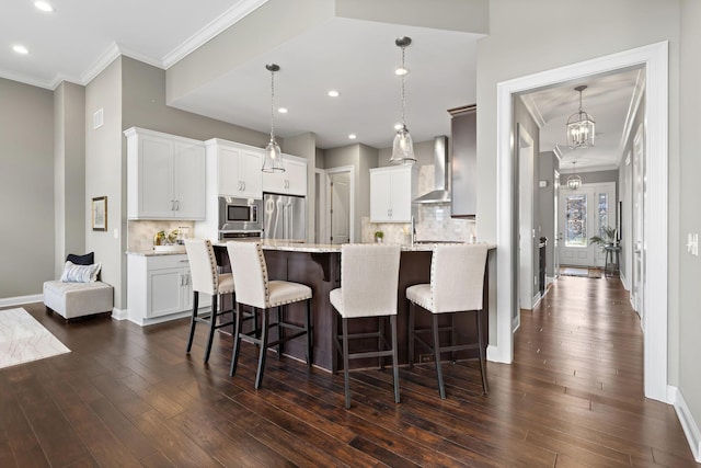 1462 Dogwood Loop, Powell, OH 43065 - kitchen with wall chimney range hood, stainless steel appliances, dark wood-style floors, and a breakfast bar