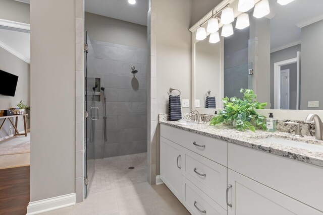 1462 Dogwood Loop, Powell, OH 43065 - bathroom featuring a stall shower, double vanity, ornamental molding, and a sink