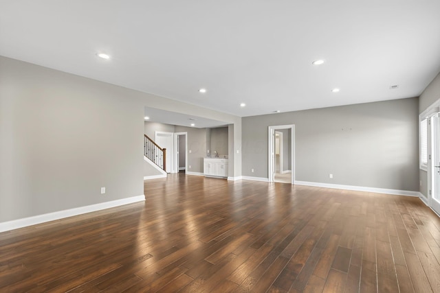 1462 Dogwood Loop, Powell, OH 43065 - unfurnished living room with dark wood-style flooring, baseboards, stairway, and recessed lighting