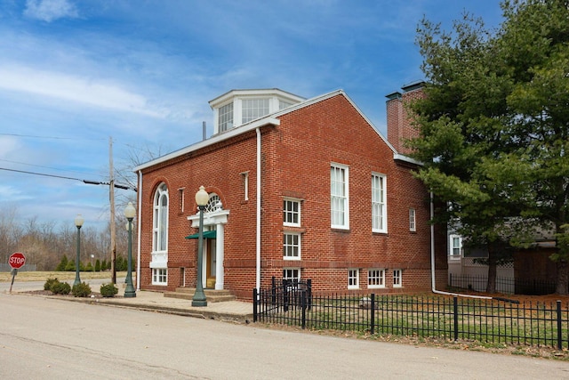 108 W Main St, Glenford, OH 43739 - view of side of property featuring a fenced front yard, brick siding, and entry steps