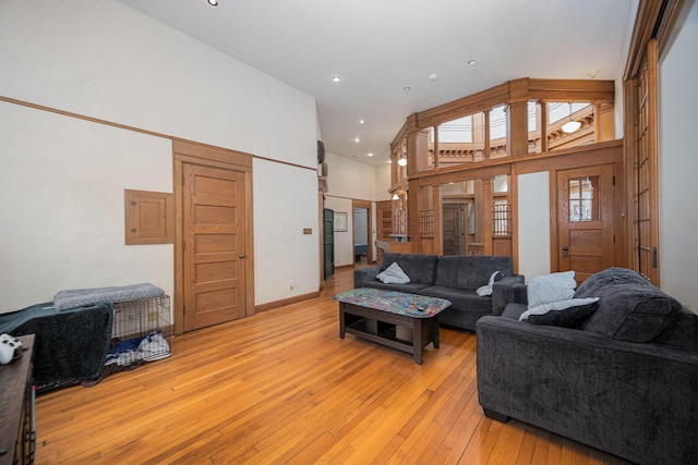 108 W Main St, Glenford, OH 43739 - living area featuring recessed lighting, baseboards, a high ceiling, and light wood finished floors