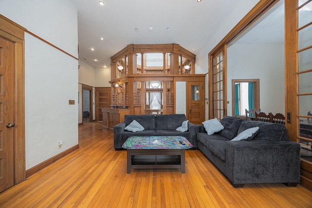 108 W Main St, Glenford, OH 43739 - living room with recessed lighting, light wood-type flooring, baseboards, and a towering ceiling