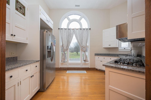 108 W Main St, Glenford, OH 43739 - kitchen with visible vents, light wood-style flooring, appliances with stainless steel finishes, and white cabinetry