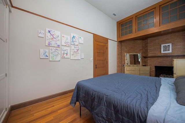 108 W Main St, Glenford, OH 43739 - bedroom featuring visible vents, baseboards, wood finished floors, and a fireplace