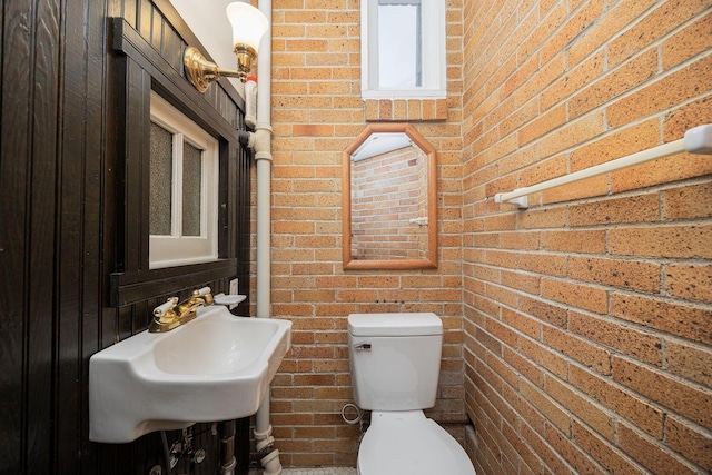 108 W Main St, Glenford, OH 43739 - half bath featuring toilet, brick wall, and a sink